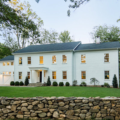 Example of a large country white two-story wood exterior home design in New York