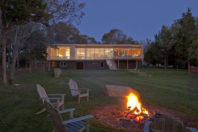 Example of a beach style two-story wood exterior home design in Providence