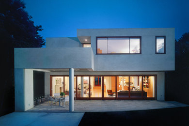 Inspiration for a large modern gray three-story stucco exterior home remodel in Los Angeles