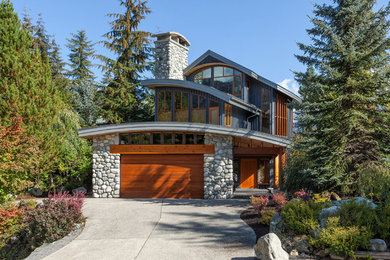 Large minimalist gray three-story mixed siding exterior home photo in Vancouver with a metal roof