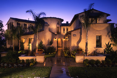Inspiration for a large mediterranean two-story stucco gable roof remodel in San Diego