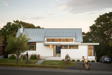 Inspiration for a white contemporary bungalow detached house in Boston with a pitched roof and a metal roof.