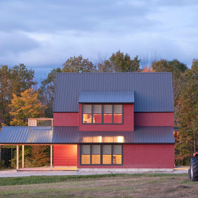 Farmhouse red two-story wood exterior home idea in Portland Maine with a metal roof