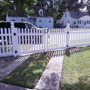 White vinyl picket fence with driveway gate