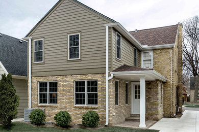 Mid-sized transitional beige two-story brick exterior home idea in Milwaukee