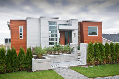Example of a mid-sized trendy gray one-story concrete fiberboard exterior home design in Vancouver