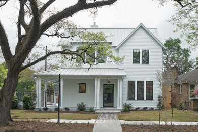 Huge country two-story exterior home photo in Houston with a metal roof and a gray roof