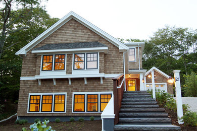 Inspiration for a large craftsman beige two-story wood exterior home remodel in Boston with a clipped gable roof