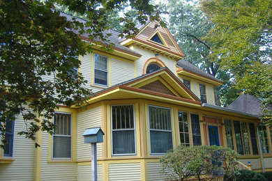 Elegant yellow two-story exterior home photo in Boston