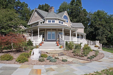 Cottage beige two-story vinyl exterior home photo in Baltimore