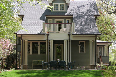 Photo of a green classic two floor house exterior in New York with wood cladding.
