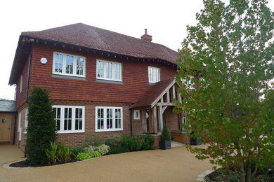 Design ideas for a large classic brick house exterior in Sussex with three floors.