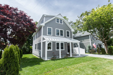 Example of a small trendy gray three-story wood exterior home design in Providence with a shingle roof