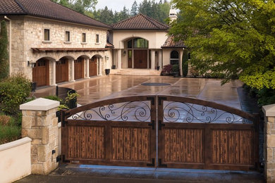 Example of a huge tuscan beige two-story stucco exterior home design in Portland with a hip roof