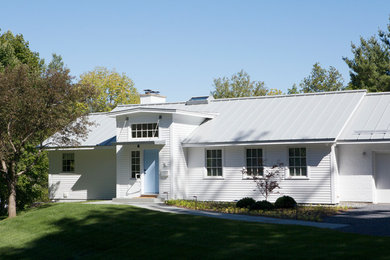 Idee per la casa con tetto a falda unica grande bianco moderno a due piani con rivestimento con lastre in cemento