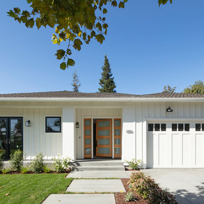 Example of a large cottage white one-story wood house exterior design in San Francisco with a hip roof and a shingle roof