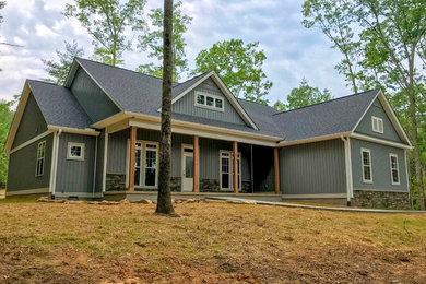 Example of a large country gray two-story vinyl exterior home design in Other with a shingle roof