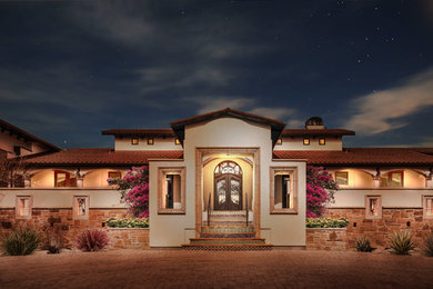 Example of a large tuscan multicolored one-story mixed siding exterior home design in Austin with a tile roof