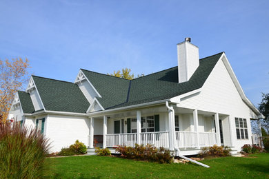 Inspiration for a mid-sized country white two-story vinyl exterior home remodel in Milwaukee with a shingle roof