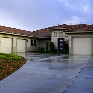 Example of a large trendy multicolored one-story stucco house exterior design with a hip roof and a shingle roof