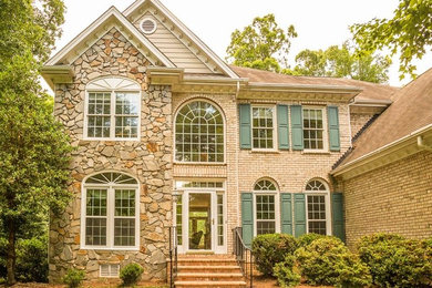 Large traditional beige two-story mixed siding exterior home idea in Raleigh
