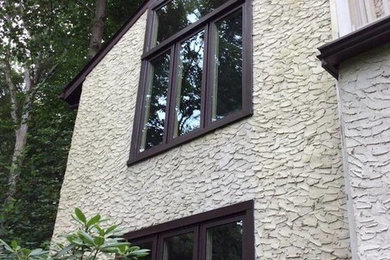Two floor house exterior in New York with stone cladding.
