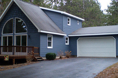 Inspiration for a mid-sized timeless blue two-story mixed siding exterior home remodel in Other with a shingle roof