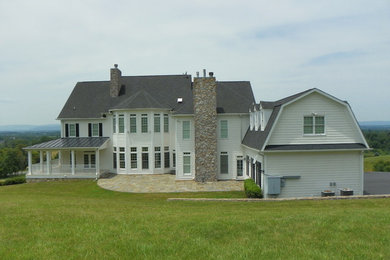 Modelo de fachada de casa blanca clásica grande de dos plantas con revestimiento de madera, tejado a dos aguas y tejado de teja de madera