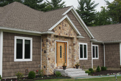 Inspiration for a brown one-story mixed siding exterior home remodel in Boston