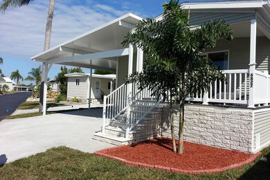 This is an example of a medium sized and beige classic bungalow house exterior in Tampa with mixed cladding and a pitched roof.