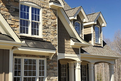 Example of a classic brown two-story stone exterior home design in Columbus