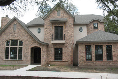 Inspiration for a large timeless red two-story mixed siding exterior home remodel in Austin