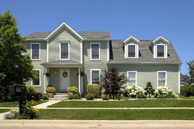 Example of a mid-sized classic brown two-story mixed siding exterior home design in Cleveland with a shingle roof
