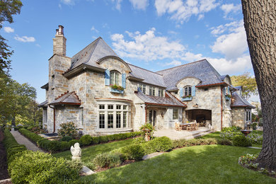 Elegant beige stone house exterior photo in Minneapolis with a shingle roof
