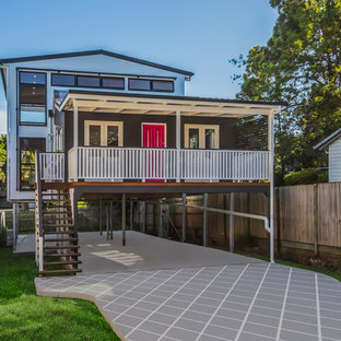 Inspiration for a large transitional two-storey grey house exterior in Brisbane with mixed siding, a gable roof and a metal roof.