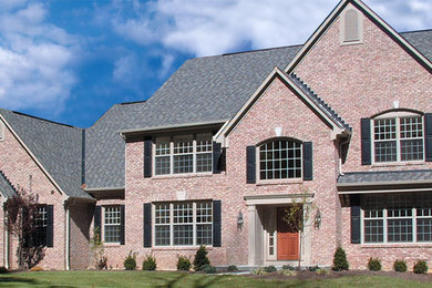 Example of a large transitional two-story brick exterior home design in Cincinnati