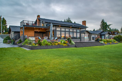 Large trendy two-story mixed siding exterior home photo in Seattle with a mixed material roof