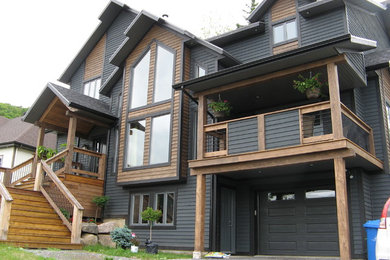 Mid-sized mountain style gray three-story wood exterior home photo in Montreal