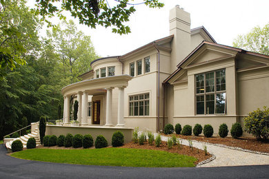 Design ideas for an expansive and beige classic two floor render house exterior in DC Metro.
