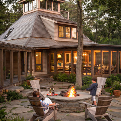 Rustic wood exterior home idea in Boston with a hip roof