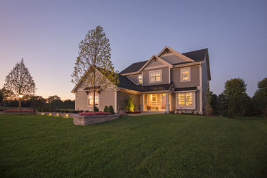 Large island style gray two-story wood exterior home photo in Milwaukee