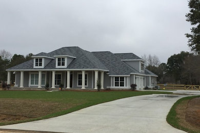 Example of a large classic gray two-story concrete fiberboard exterior home design in Other with a hip roof