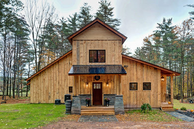 Mid-sized mountain style brown two-story wood exterior home photo in New York with a metal roof