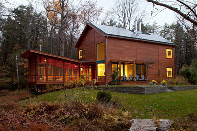 Photo of a contemporary house exterior in New York with wood cladding.