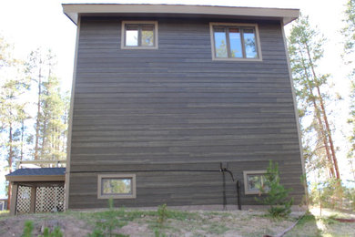 Immagine della villa marrone rustica a tre piani di medie dimensioni con rivestimento in legno e tetto a capanna