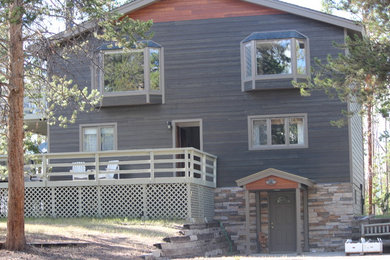 Mid-sized mountain style gray three-story wood exterior home photo in Denver