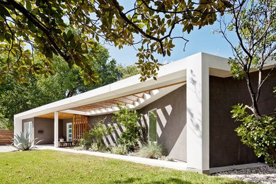 Inspiration for a contemporary gray one-story stucco exterior home remodel in Austin with a shed roof