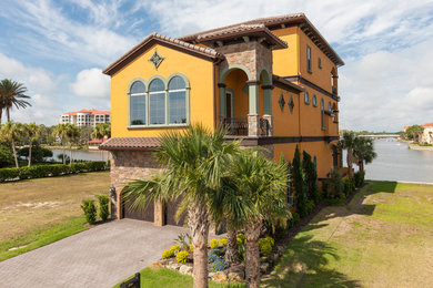 Inspiration for a yellow mediterranean detached house in Orlando.