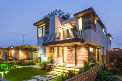 Inspiration for a mid-sized contemporary multicolored two-story mixed siding exterior home remodel in Los Angeles with a mixed material roof