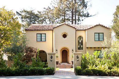 Inspiration for a mid-sized mediterranean beige two-story stucco gable roof remodel in San Francisco